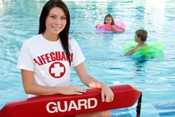 lifeguard sitting by public pool