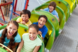 children riding roller coaster
