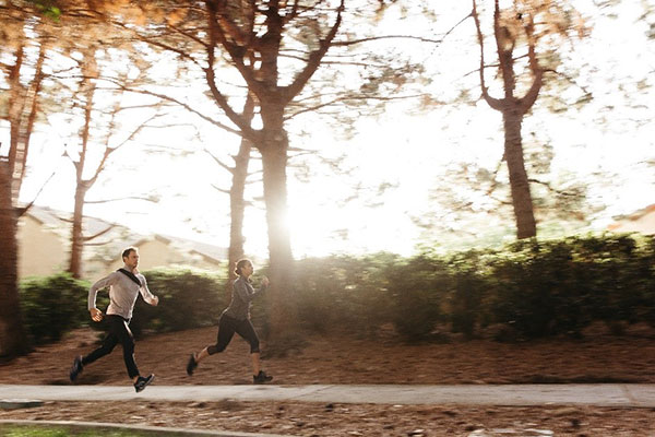 Man and woman running outside
