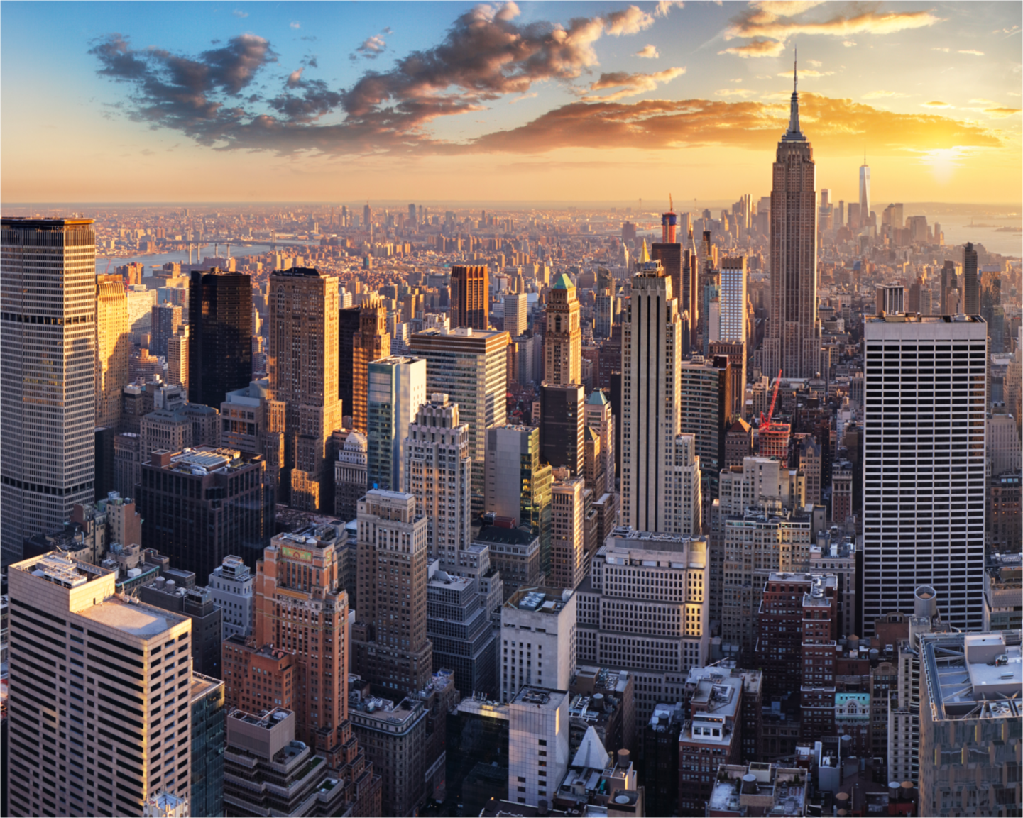 A large city with tall buildings at sunset