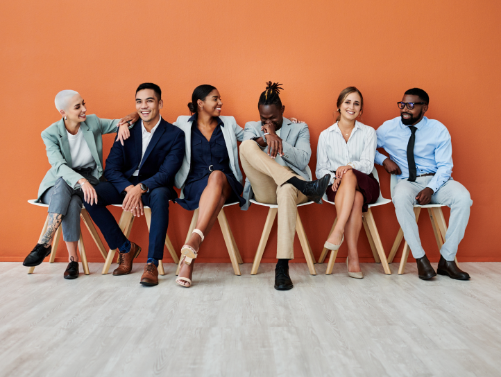 Several office workers sitting on chairs talking