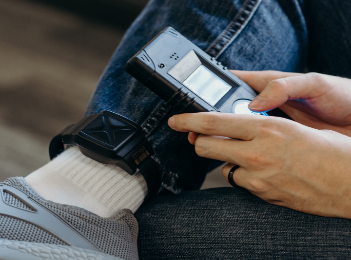 Shows the hands of a person looking at their phone