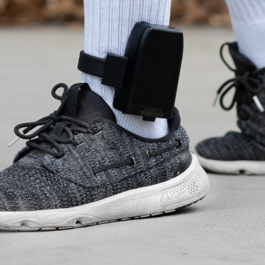 Man's foot showing a GPS tracking device around his ankle