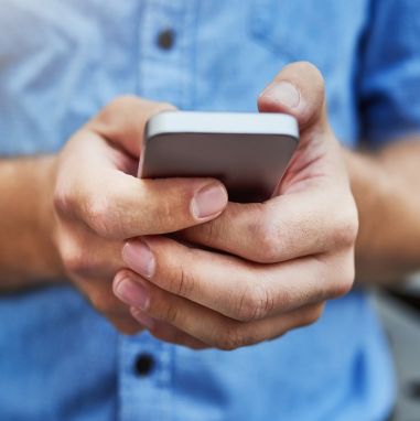 A person's hands holding onto a mobile phone