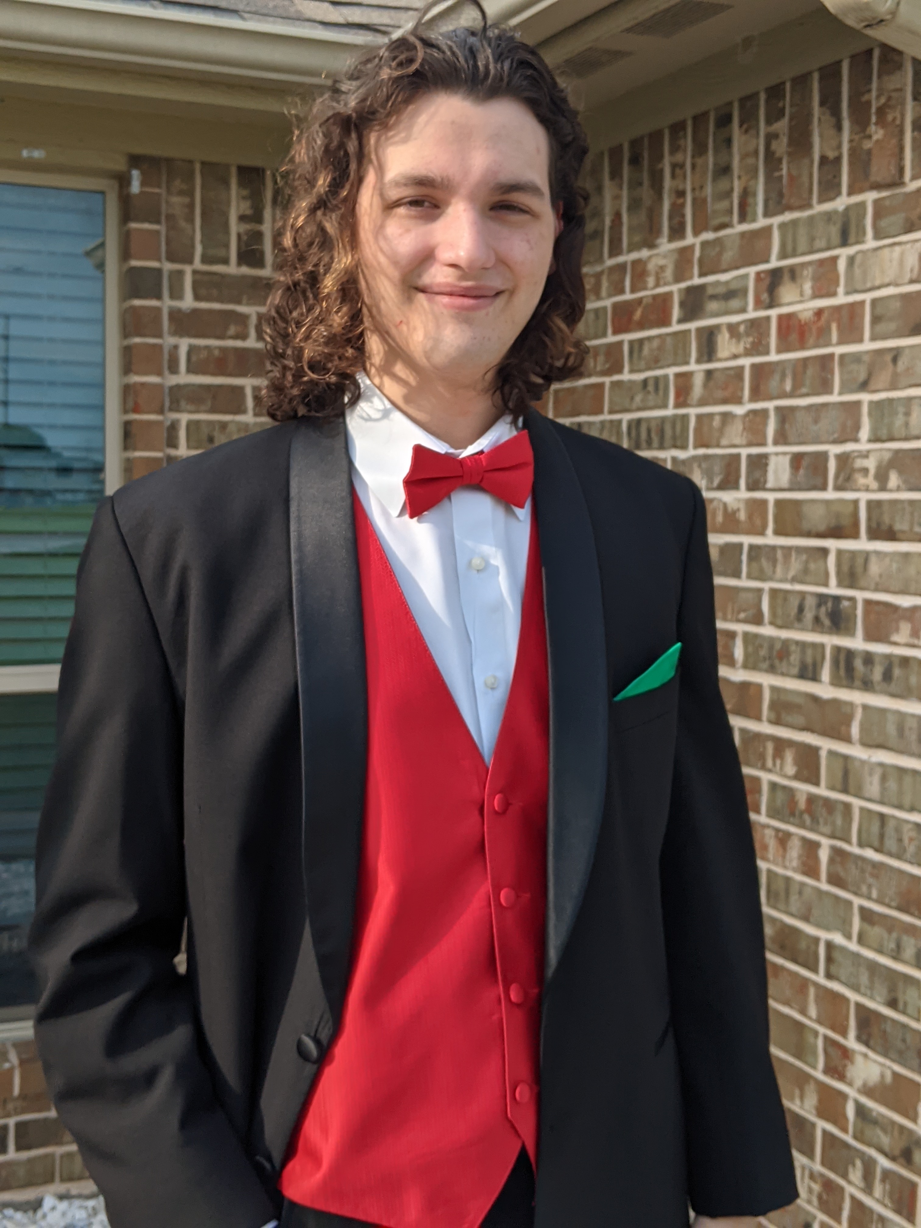 Image of a young smiling man in a tuxedo