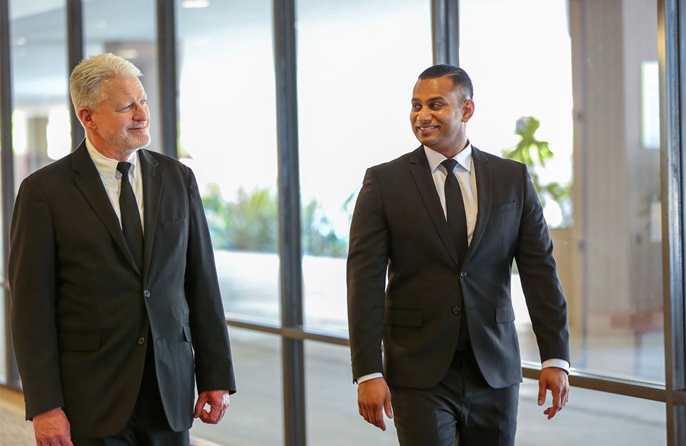 two security professionals walking in convention center