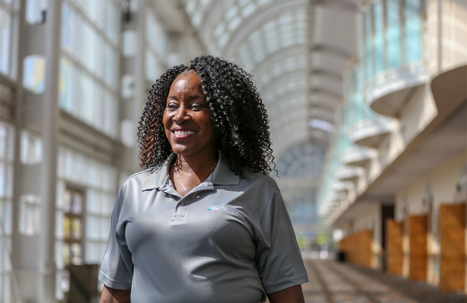 security professional walking and smiling in convention center