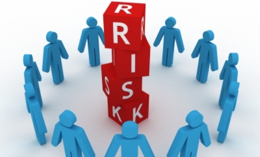 people standing in a circle around blocks that spell risk