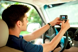 man texting while driving