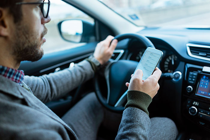 Man texting while driving