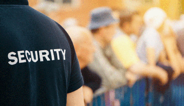 Man wearing black shirt with the word "security" on the back