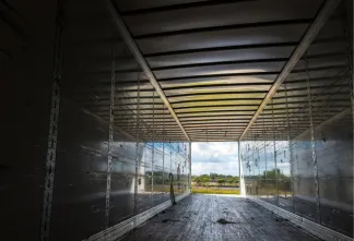 View from inside an empty trailer truck, representing a common environment used in human trafficking transport