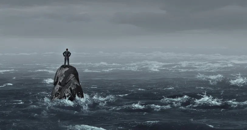 Person standing on a rock during the storm