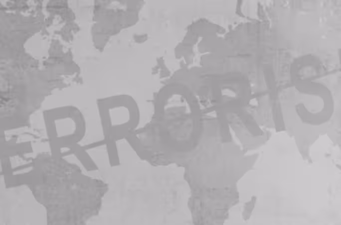Gray world map with bold typography reading “TERRORISM” diagonally across it, representing the global impact of terrorism and security awareness.