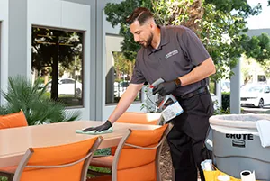 man cleaning table, janitorial services