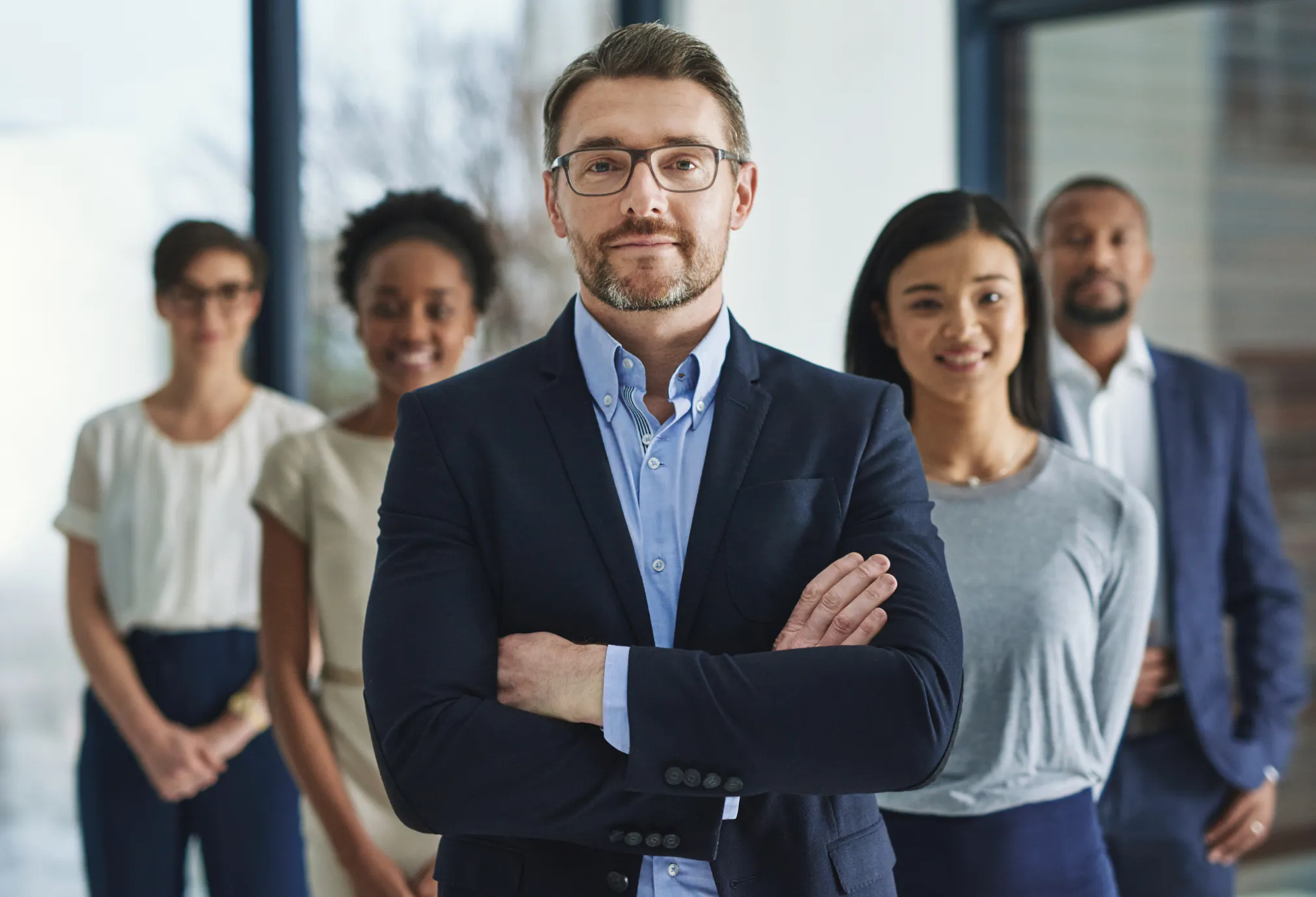 image of 5 people standing in formals