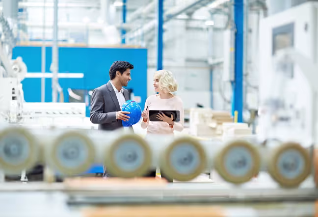 two people talking in an industrial building